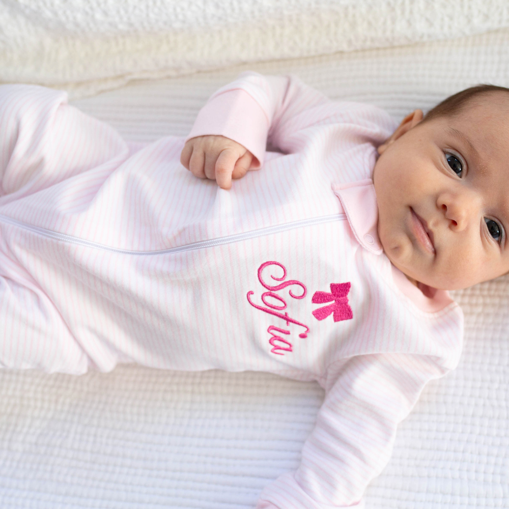 a baby wearing Classic Stripe Zipper Romper in Pink