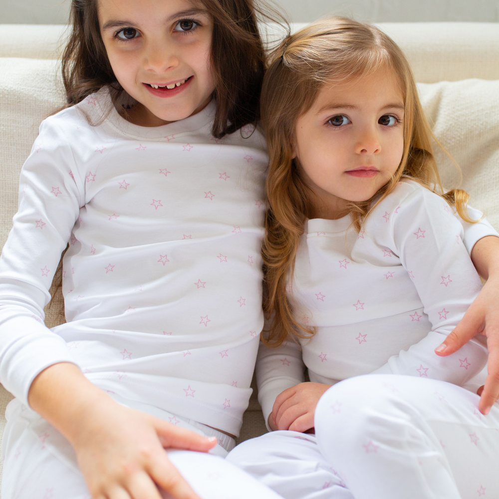 two girls in their tiny star pink pajamas