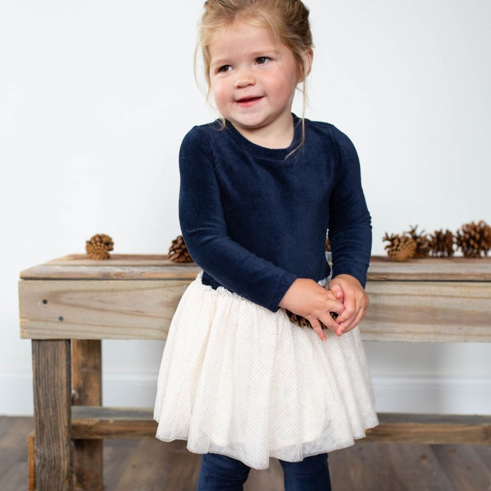 little girl wearing blue cord dress