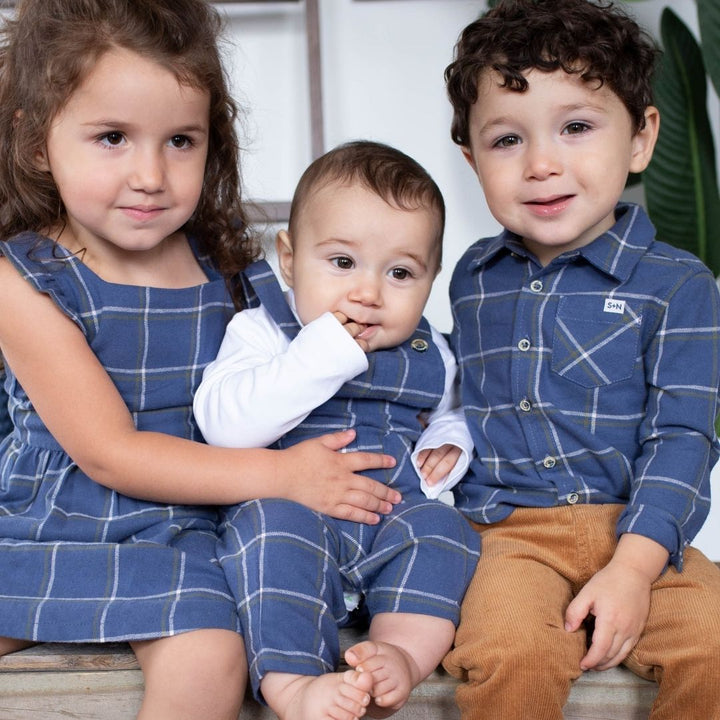 three kids wearing navy flannel outfits