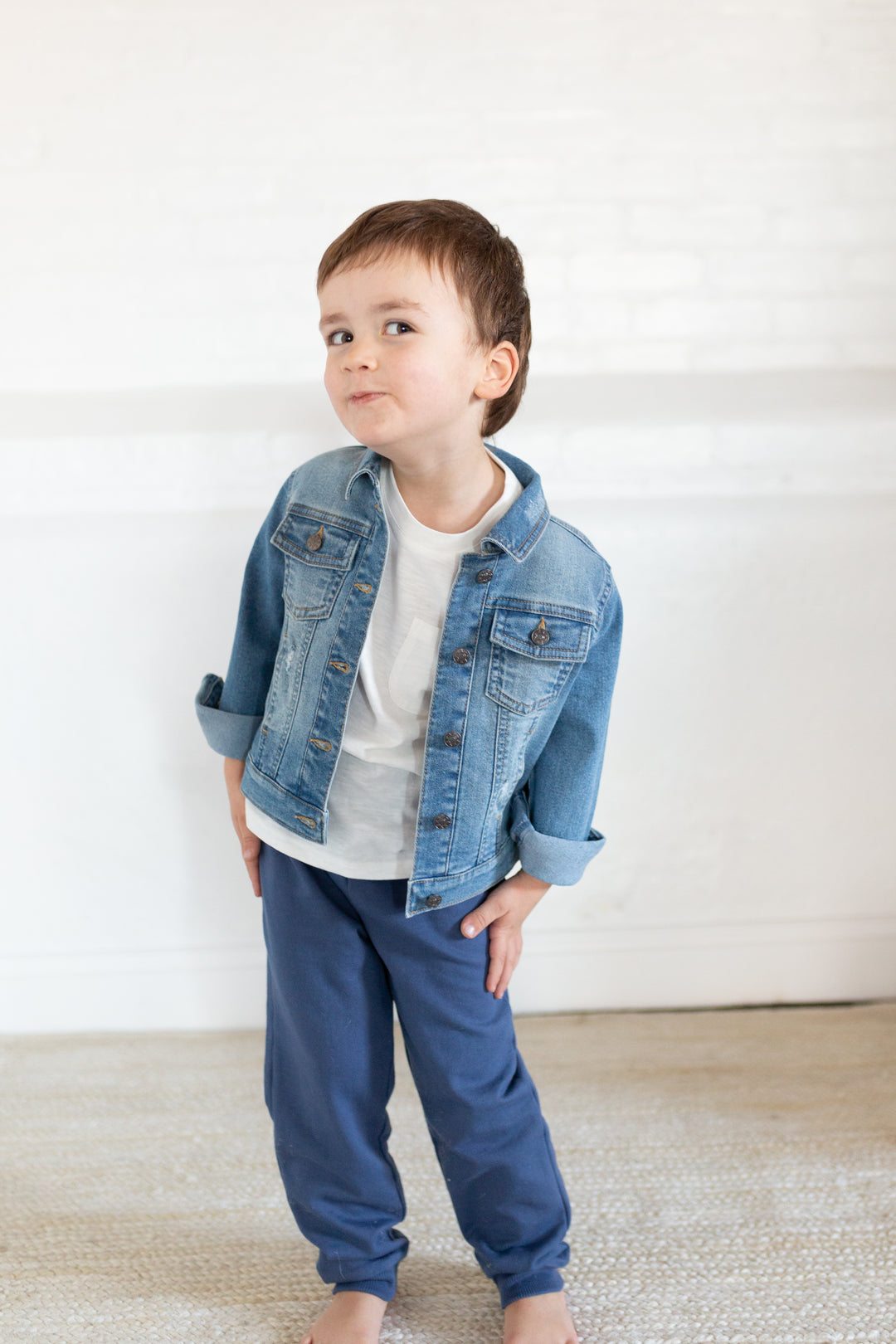 boy wearing blue joggers and denim jacket