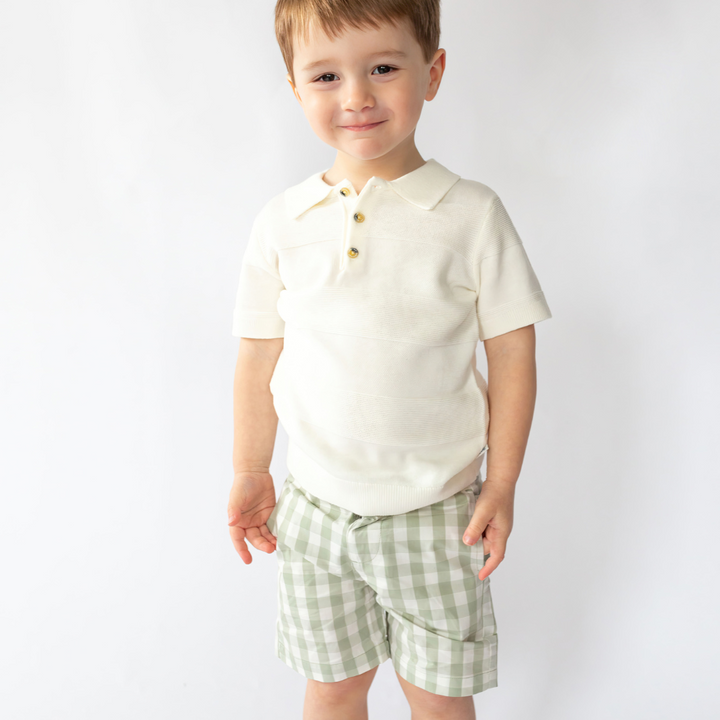 a little boy wearing Aiden Knit Polo in Angel White