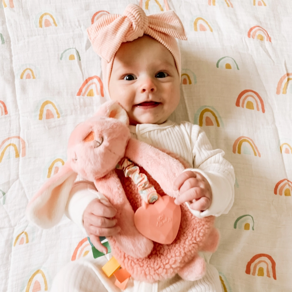 a baby hugging the Ana the Bunny Itzy Lovey Plush and Teether Toy