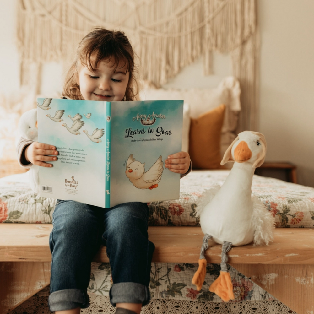 a girl reading a book with Baby Avery