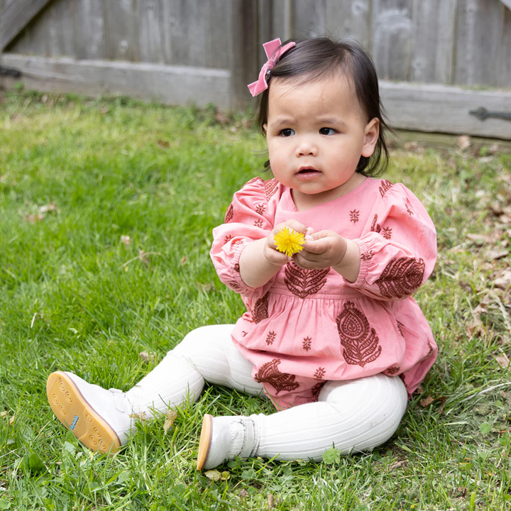 a baby girl wearing Baby Brooke Bubble - Indian Stamp Embroidery