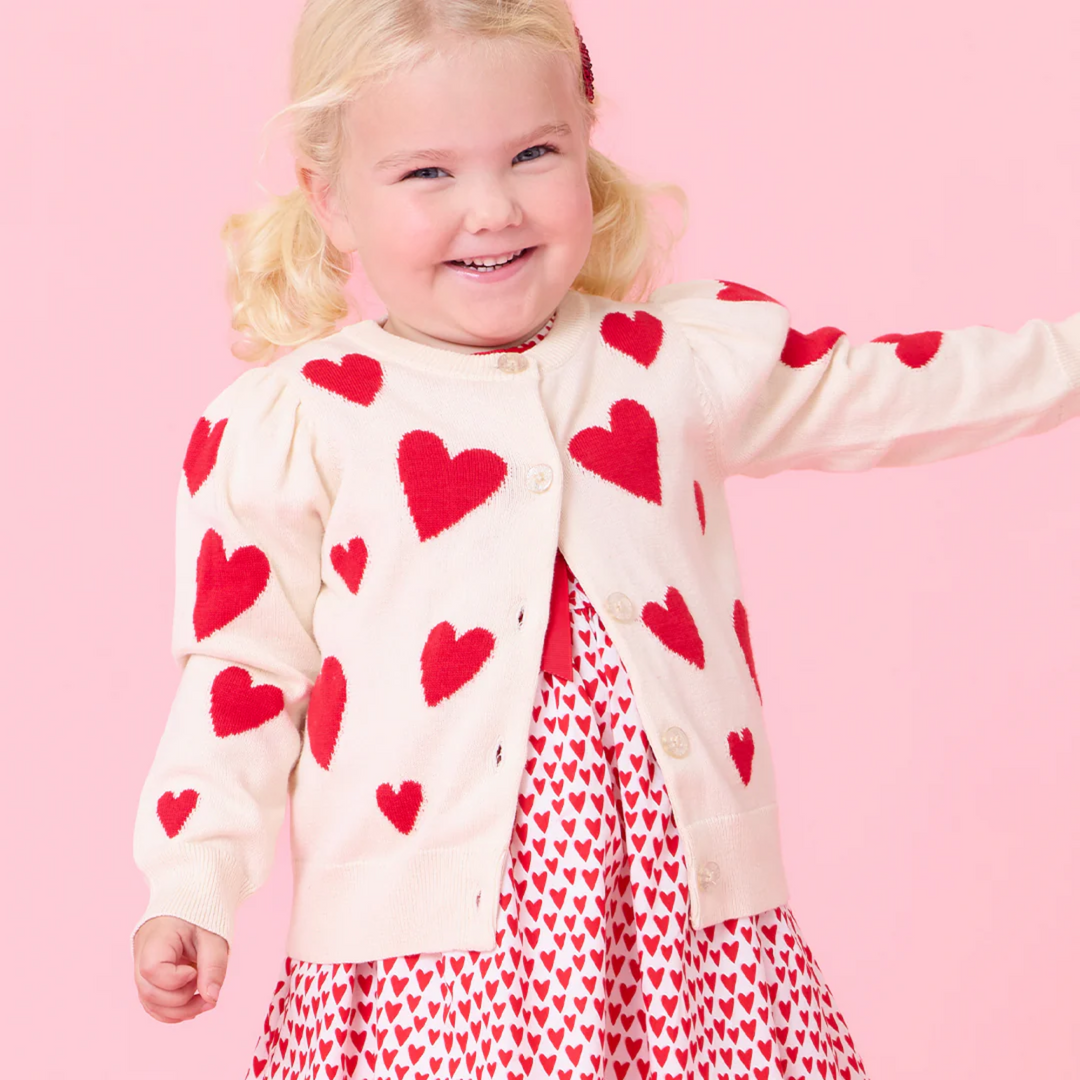 a baby wearing Baby Constance Sweater - Cream and Red Hearts