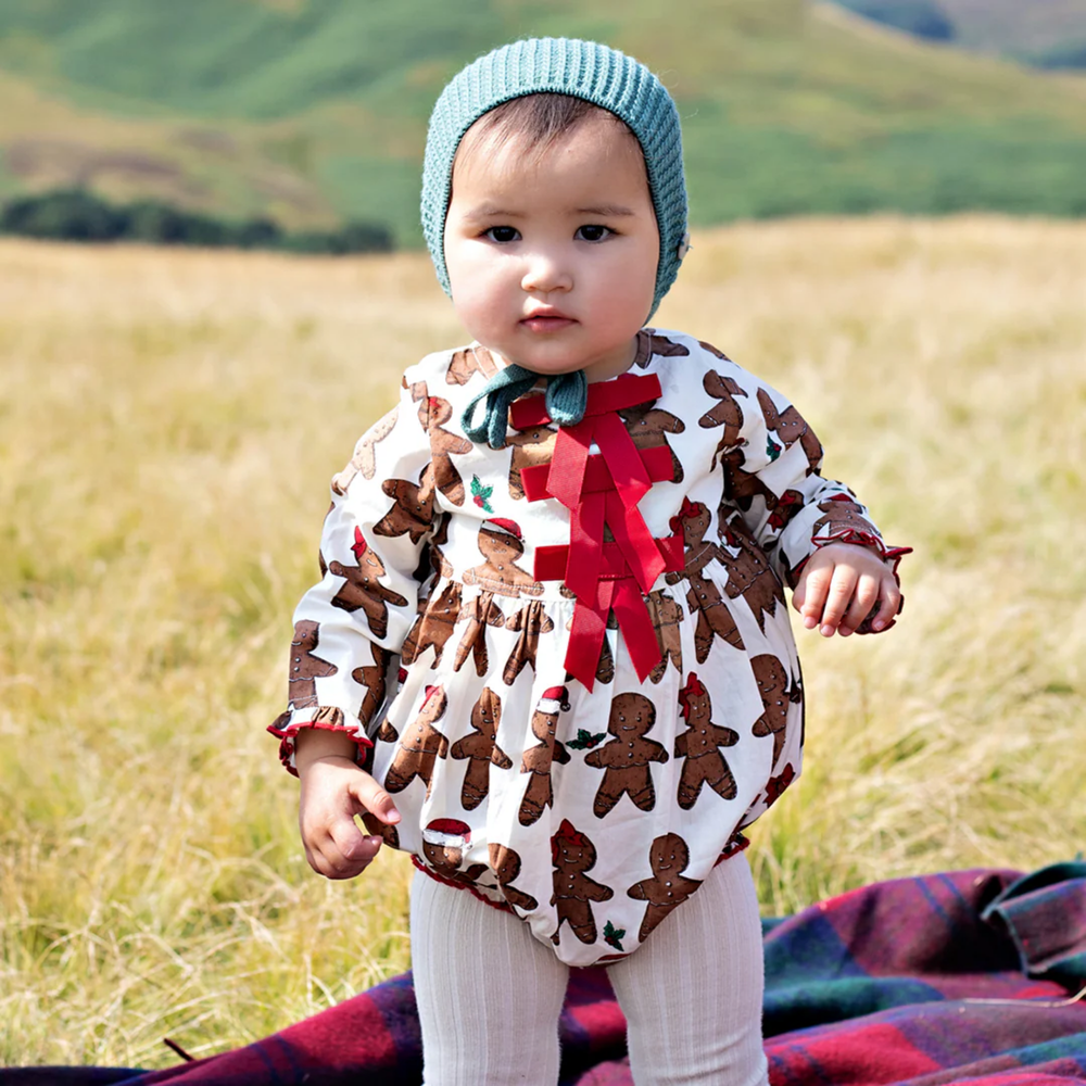 a baby wearing Baby Hermione Bubble - Gingerbread Cookie