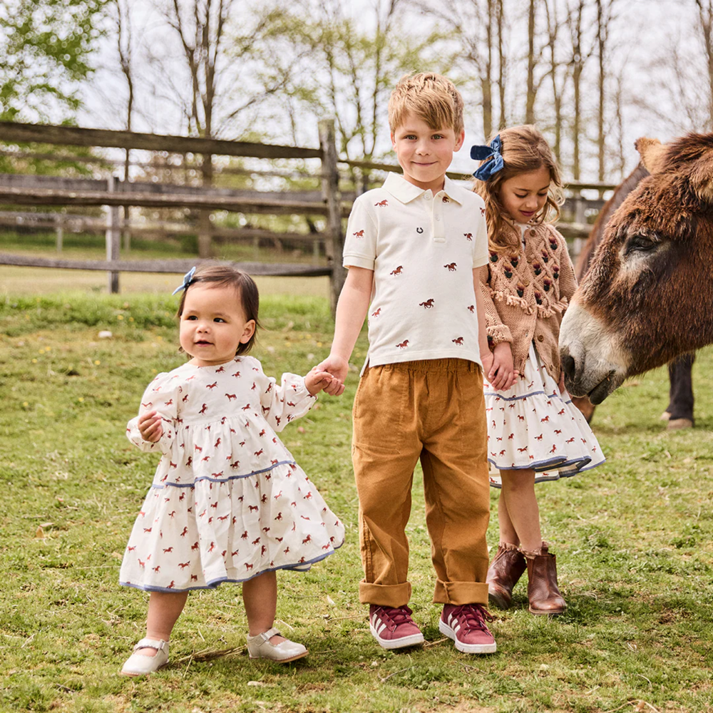 a baby girl wearing Baby Julia Dress Set - Tiny Horses