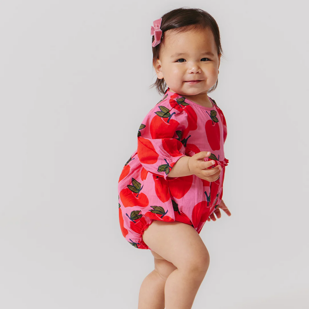 a baby girl wearing Baby Rowan Bubble - Pink Apples