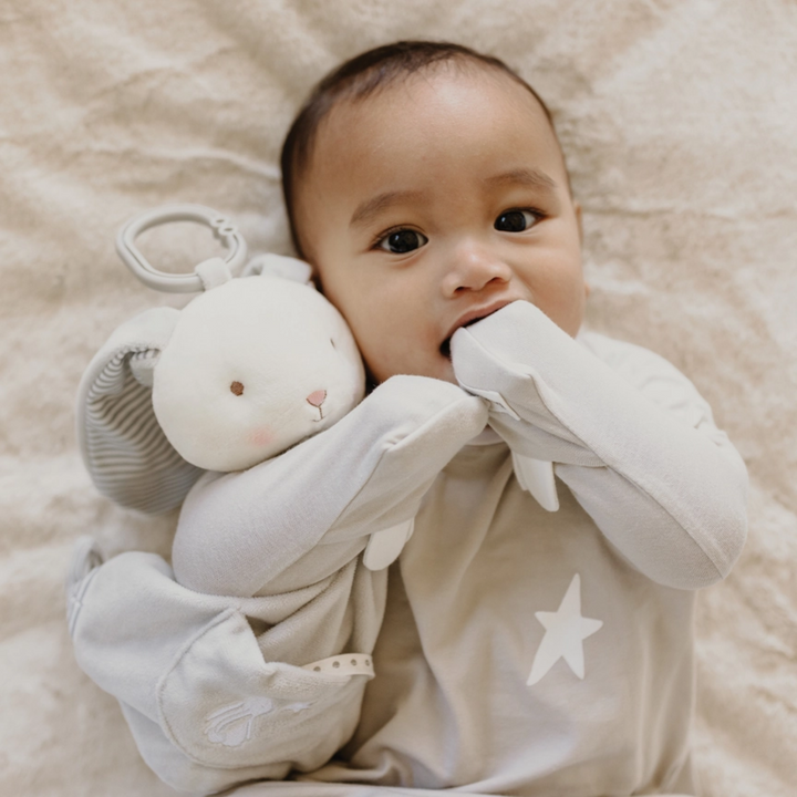 a baby hugging the Bloom's Activity Toy