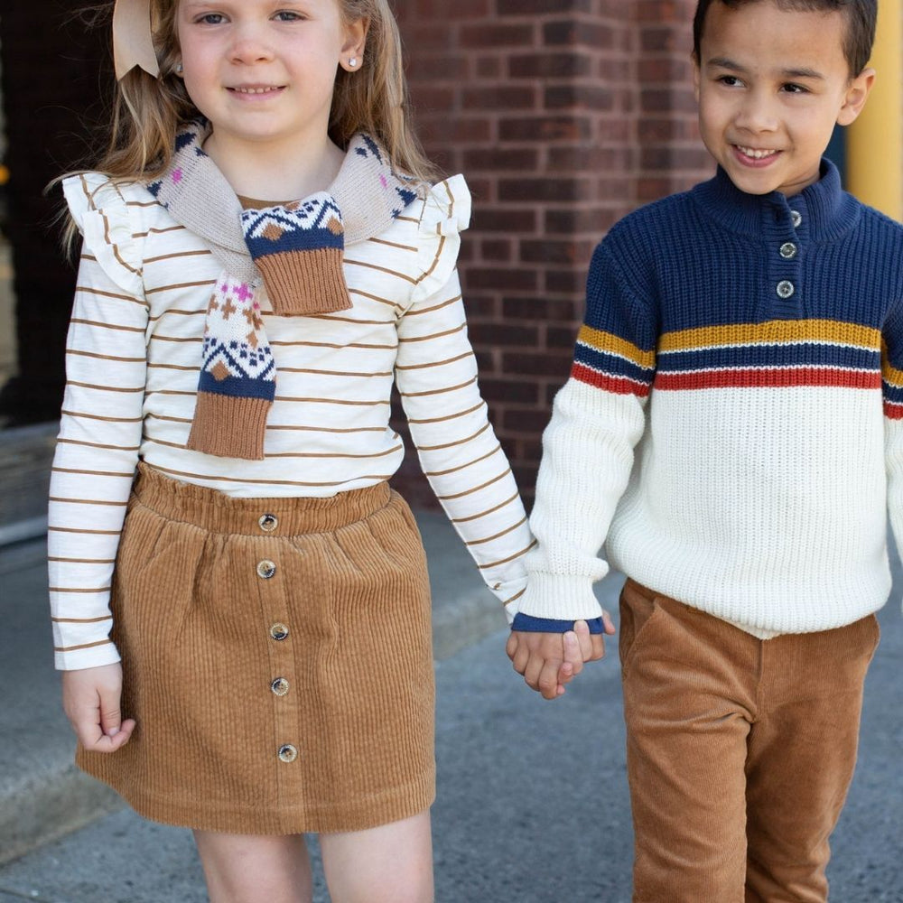 two kids holding hands in fall outfits