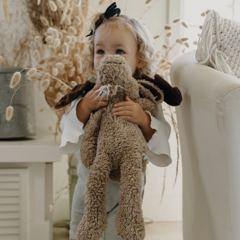 a little kid hugging Bruce the Moose 