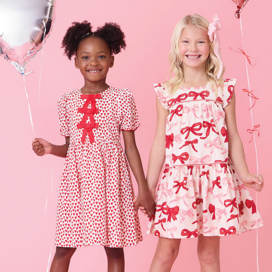 a girl wearing Camelia Dress - Valentines Bows