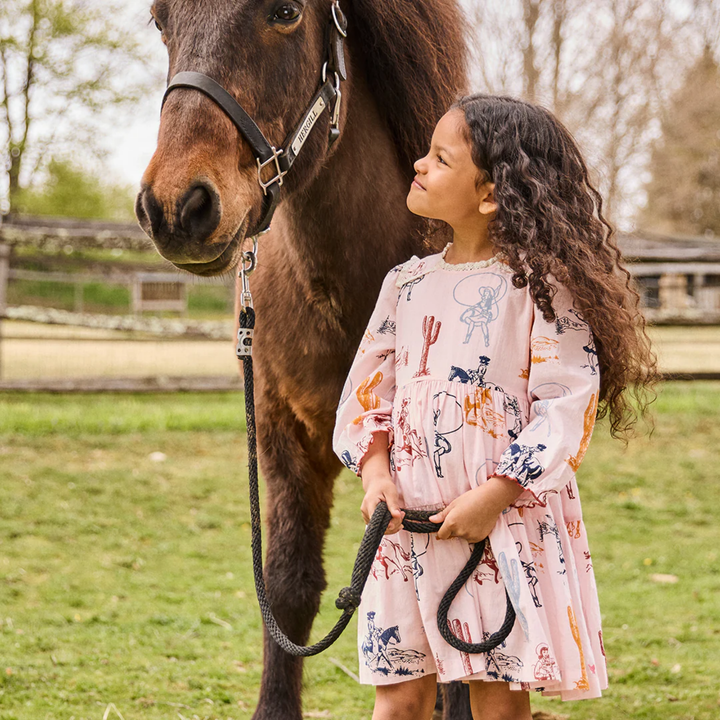 a girl wearing Charlie Dress - Pink Cowgirls