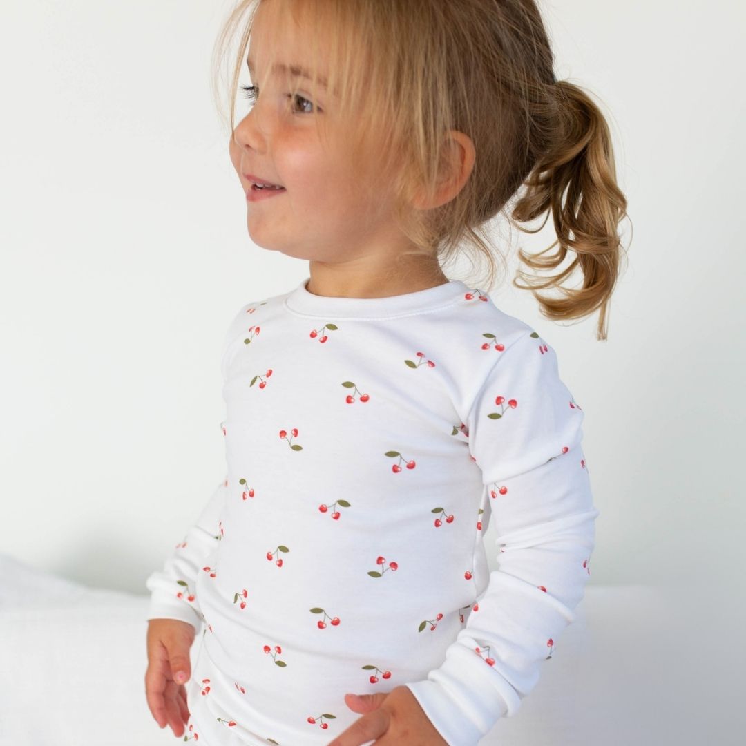 a little girl wearing Cherry Pajama Set