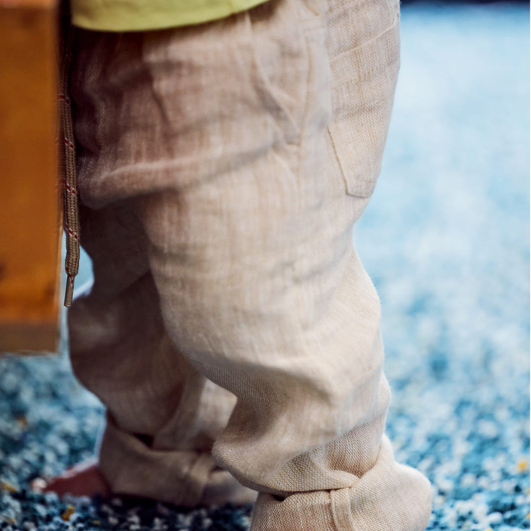 a baby wearing Baby Trousers in Linen