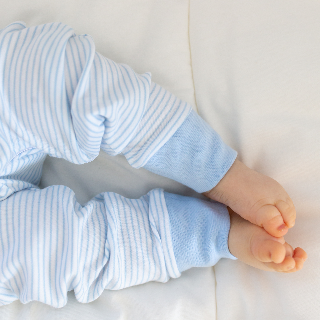 a baby wearing Classic Stripe Zipper Romper in Light Blue