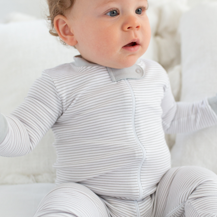 a baby wearing Classic Stripe Zipper Romper in Grey