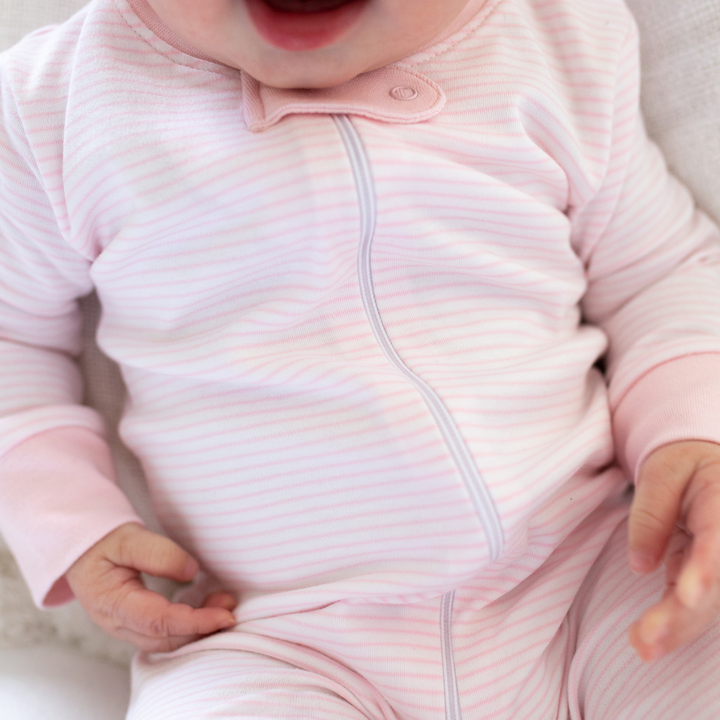 a baby wearing Classic Stripe Zipper Romper in Pink