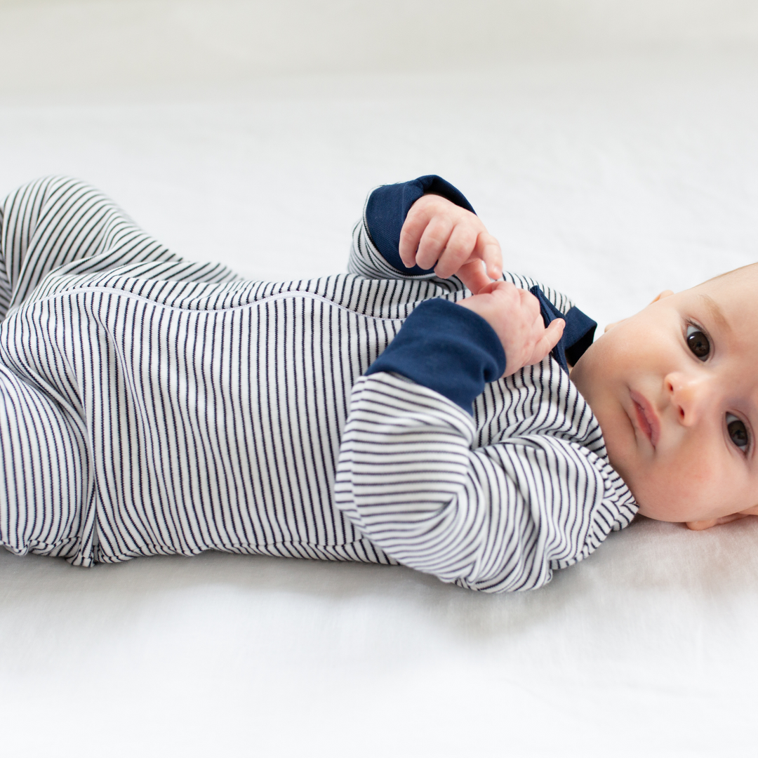 a baby wearing Classic Stripe Zipper Romper in Navy