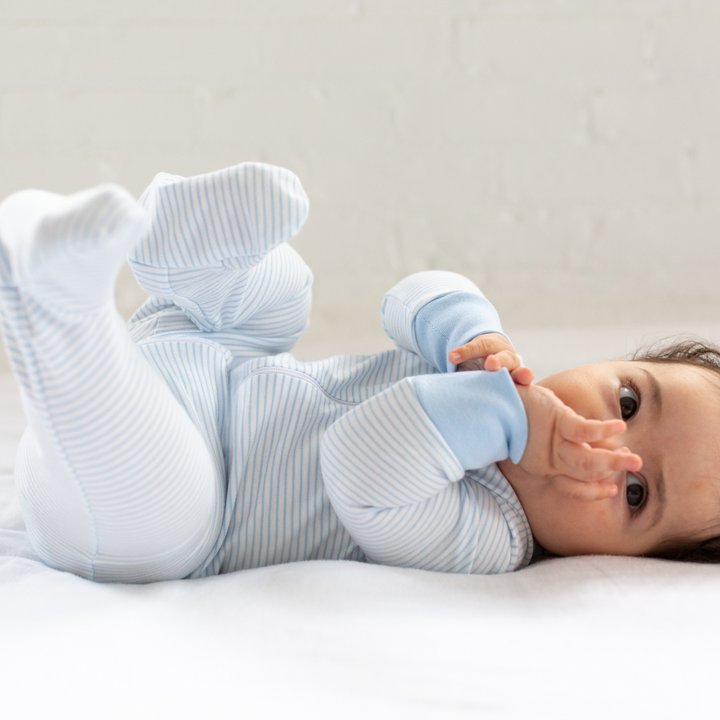 a baby wearing Classic Stripe Zipper Romper in Light Blue