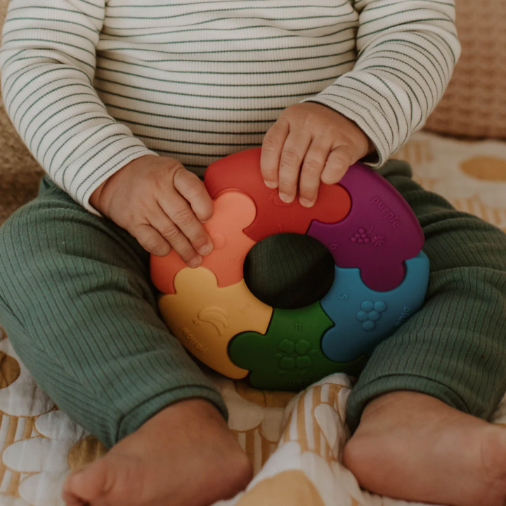 a baby holding the Colour Wheel - Pastel