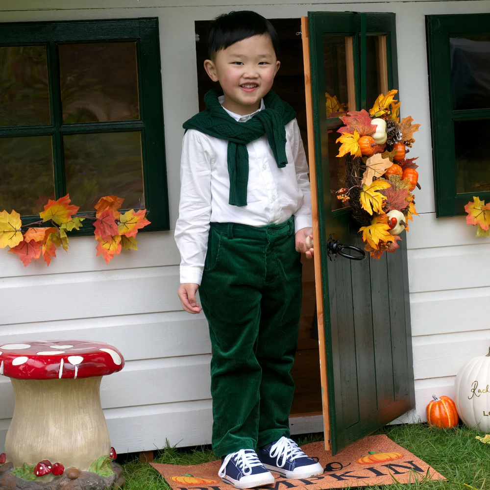 a boy wearing Cord Trousers in Green