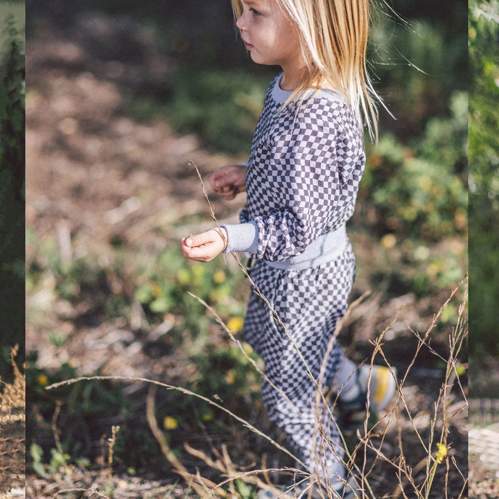 a little girl wearing Cruz Baby Jogger in Gray Skies