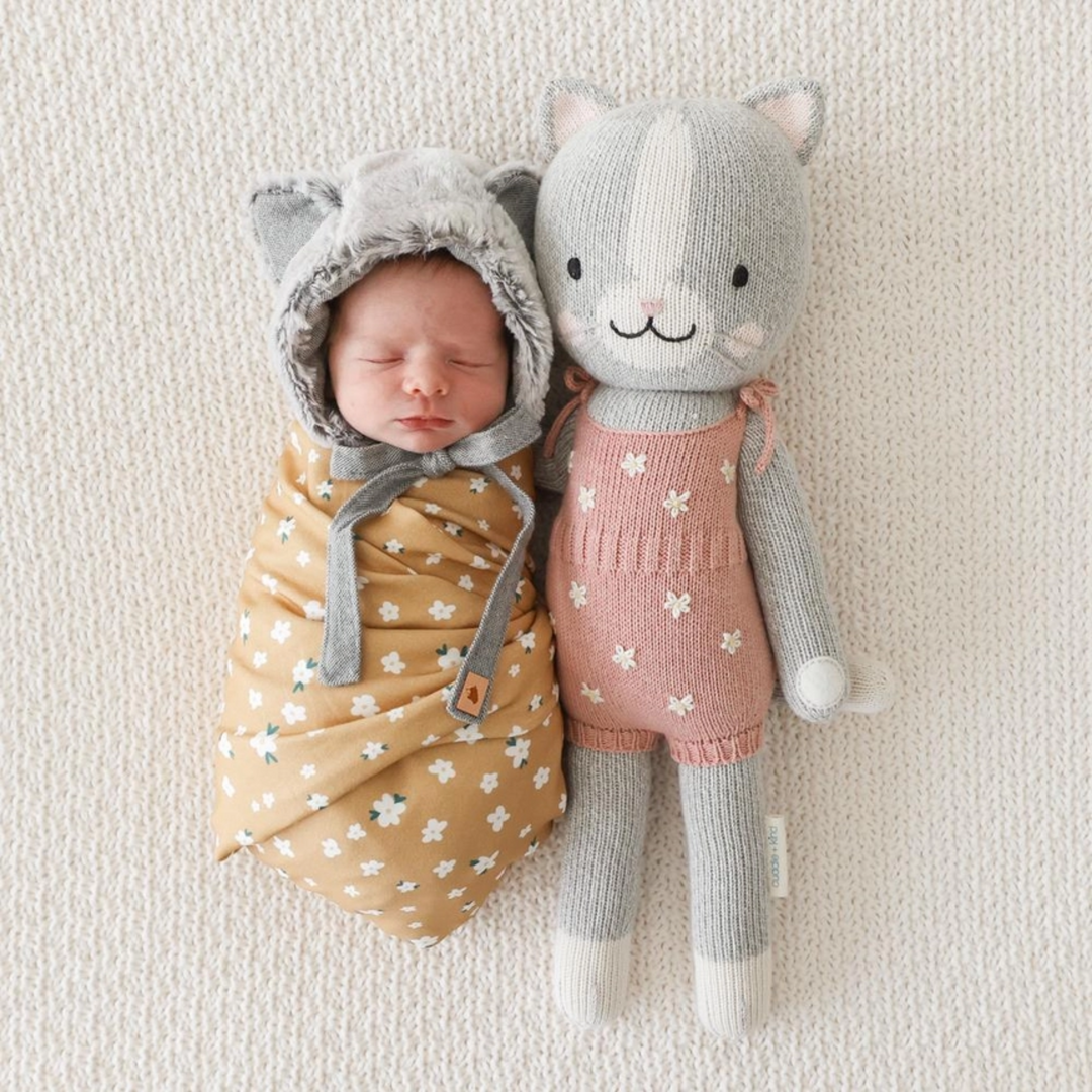 a baby with Daisy the Kitten