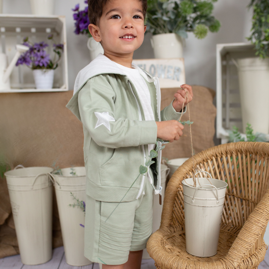 a little boy wearing Dash Zip Sweatshirt in Desert Sage