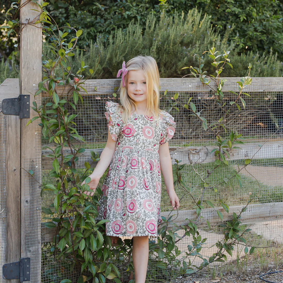 a girl wearing Elsie Dress - Pink Lisbon Floral