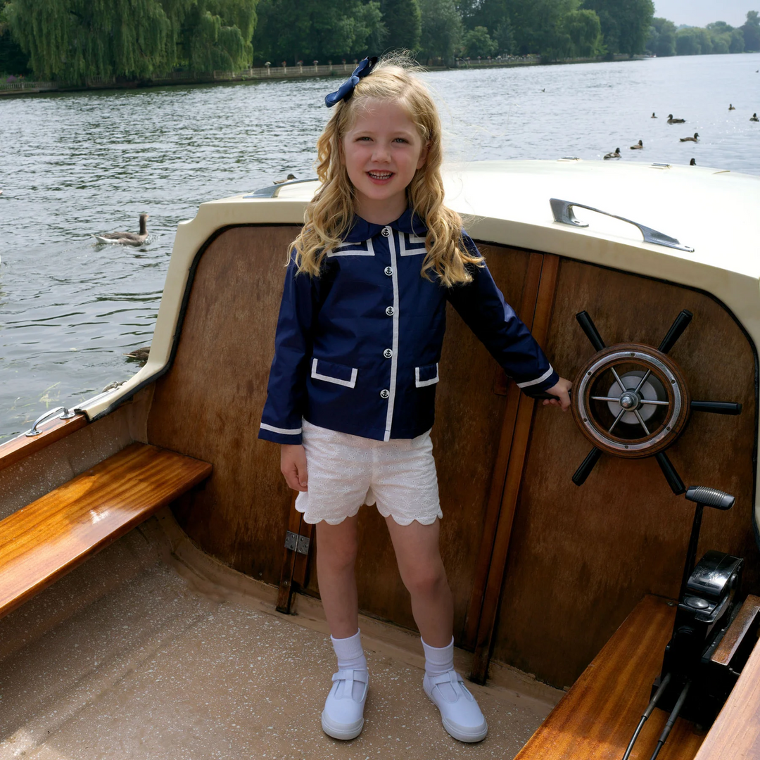 a little girl at the boat wearing Eyelet Scalloped Shorts