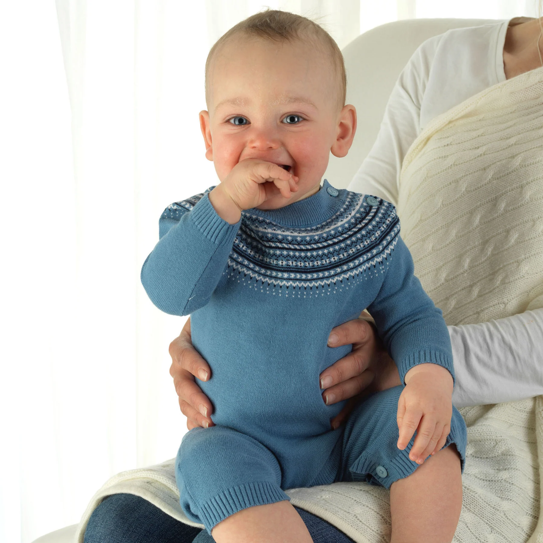 a baby boy wearing Fairisle Knit Playsuit in Blue