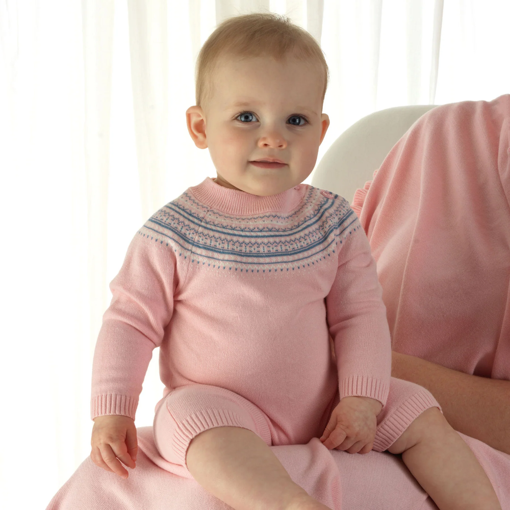 a baby girl wearing Fairisle Knit Playsuit in Pink