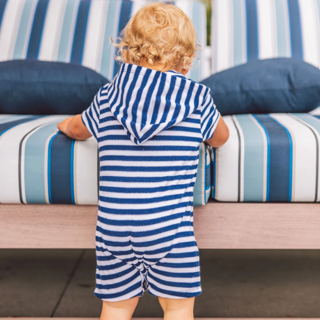 a baby wearing Finn Baby Hooded Romper in Navy and White Stripe back