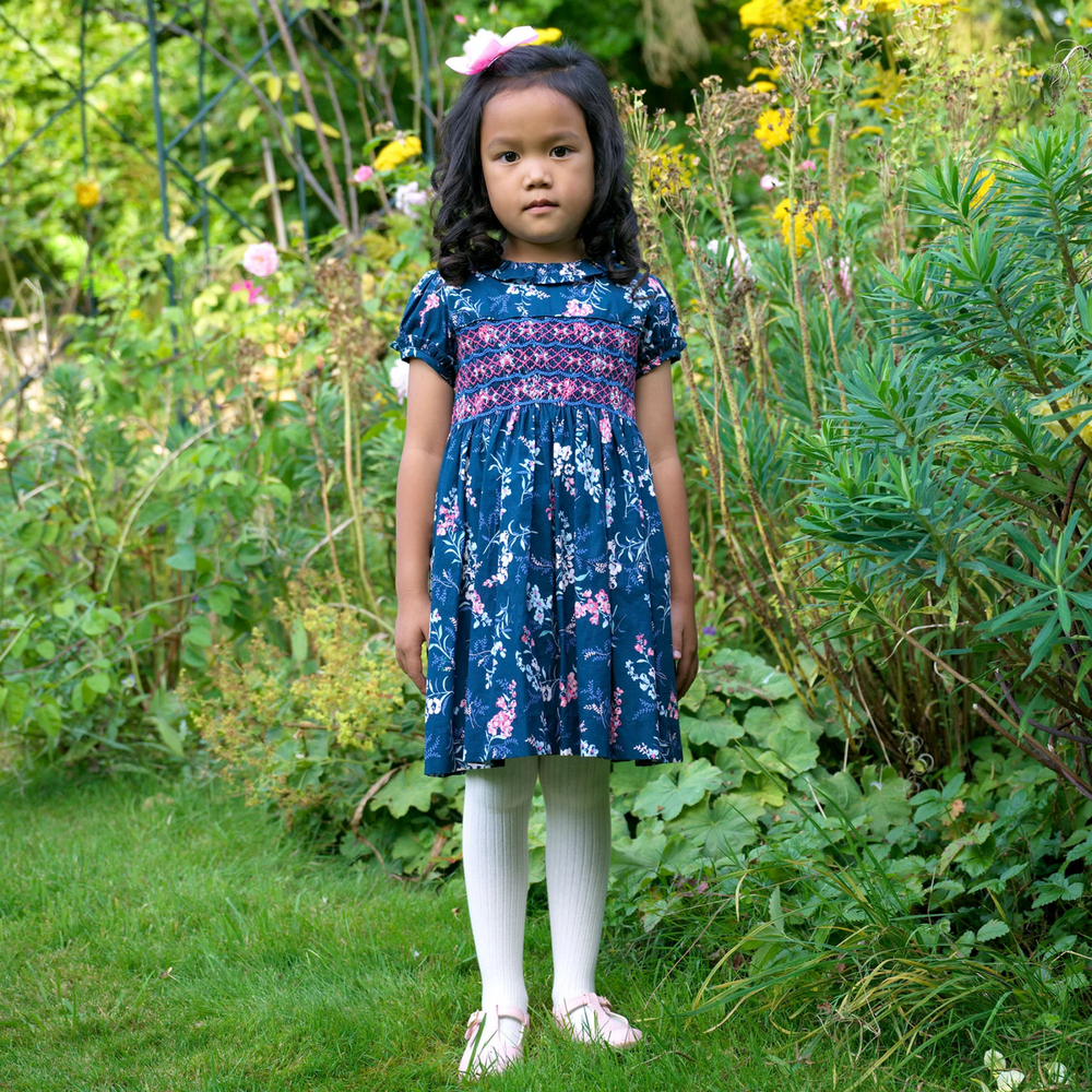 a girl wearing Floral Smocked Dress in Navy