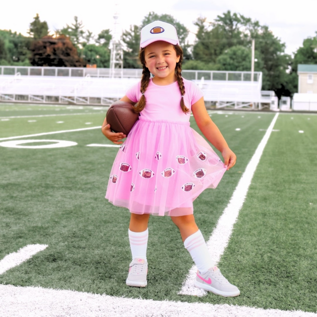 a girl wearing Football Patch Trucker Hat in Pink