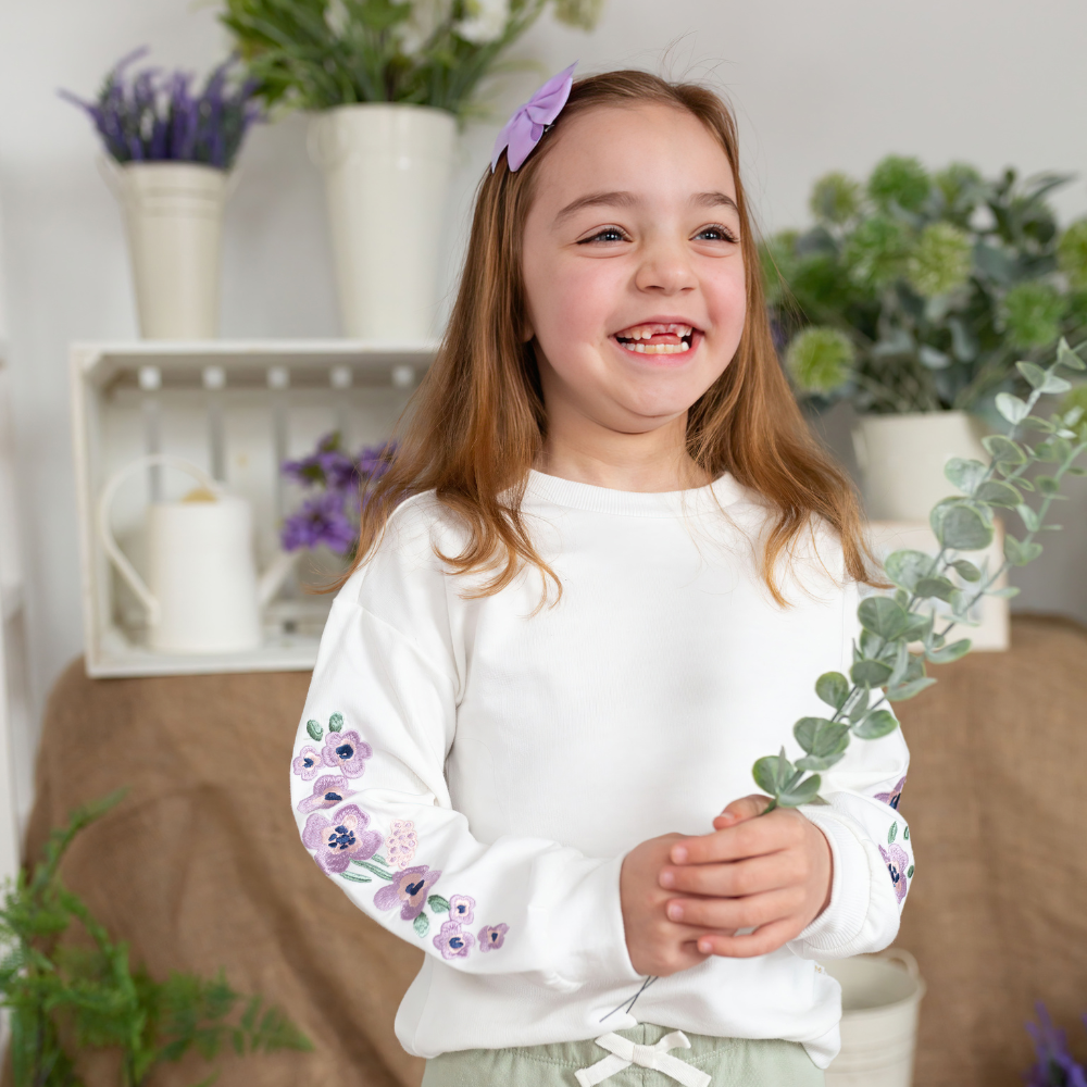 Frankie Sweatshirt with Lavender Flowers a girl holding a leaves