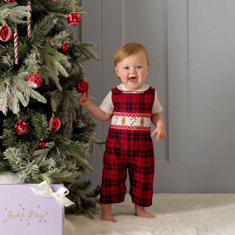 a baby girl wearing Gingerbread Smocked Dungarees