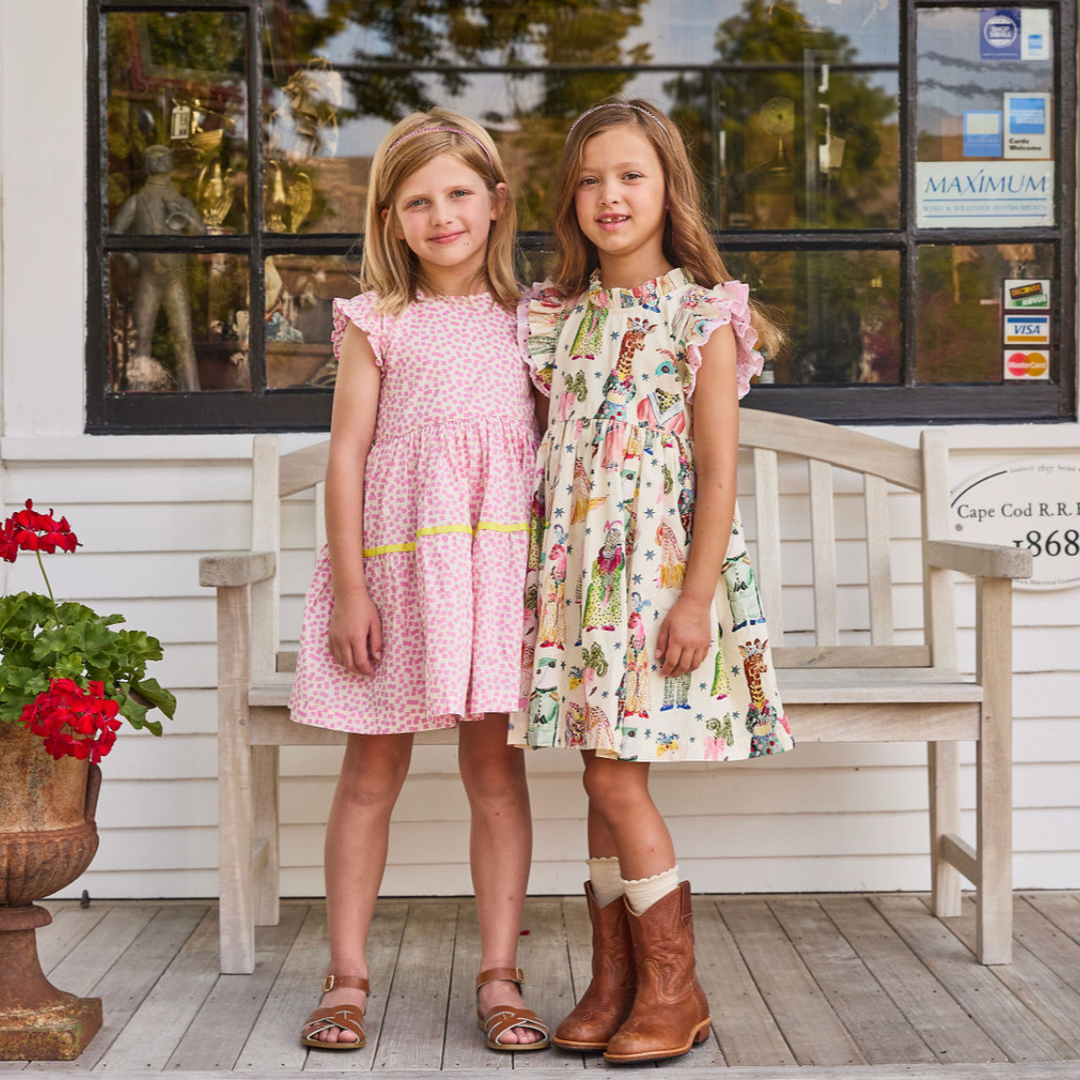 Leila Dress - Circus Animals 2 girls standing in front of a bench