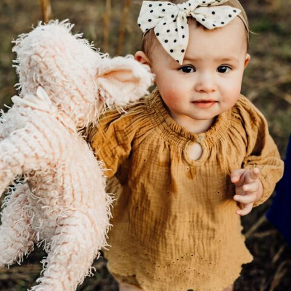 a baby holding Hammie the Pig