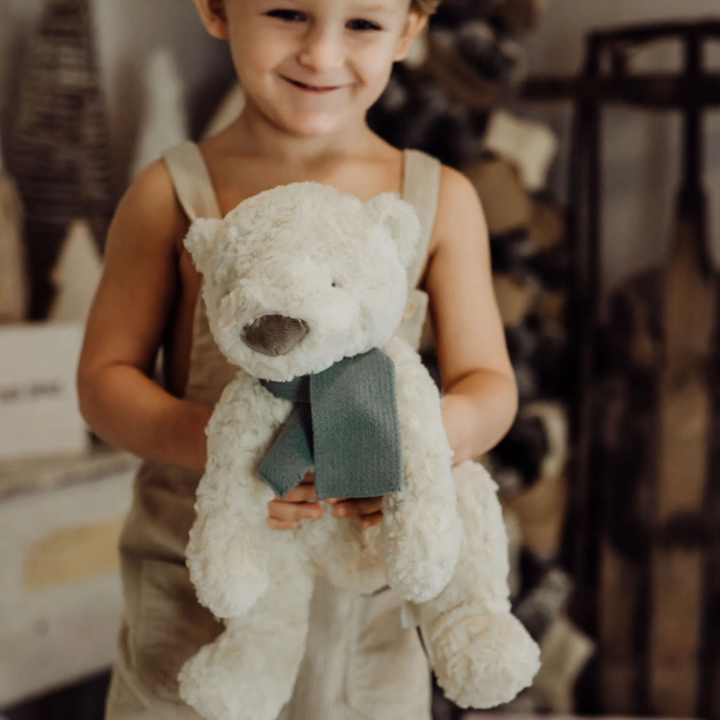 a girl holding the Boris Bear-ialis Polar Bear