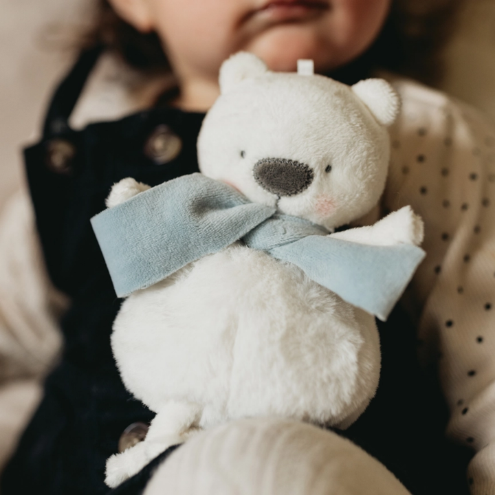 a little girl holding Boris the Polar Bear Roly Poly