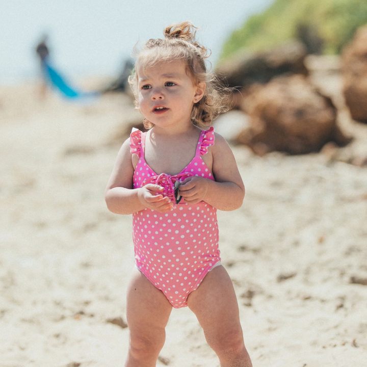 a baby wearing In a Cinch Baby One Piece Swimsuit in Pink Carnation