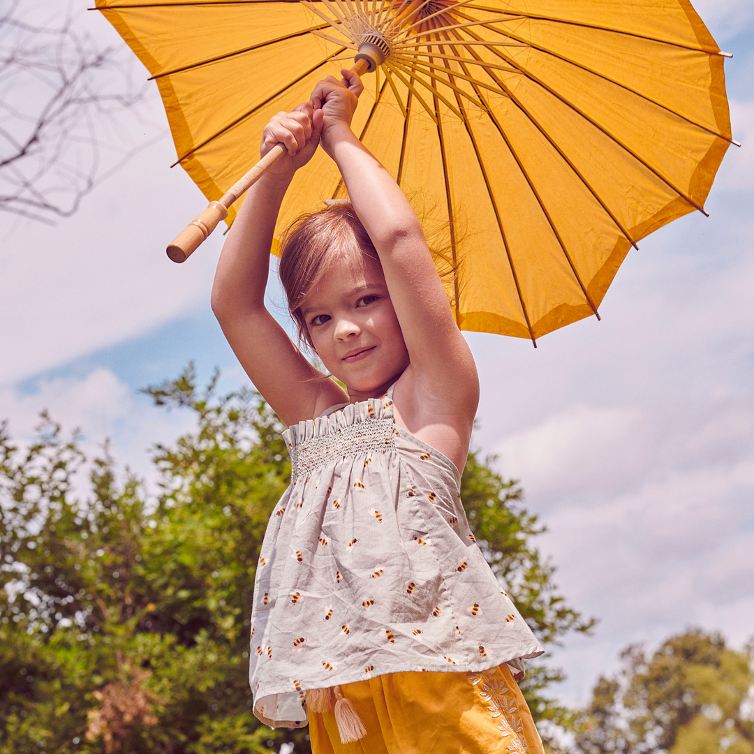 a little girl wearing Julia Blouse in Honey Bee