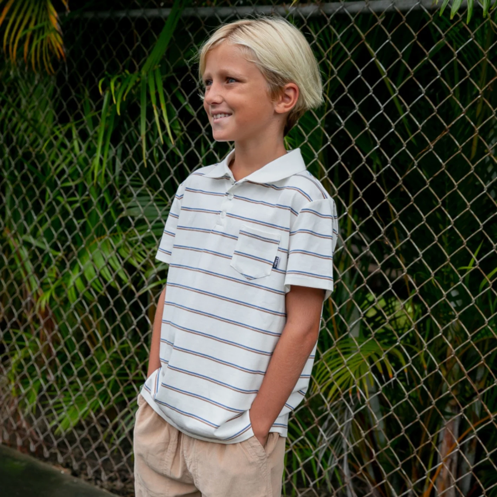 a boy wearing Kai Short Sleeve Polo Shirt in Ecru Stripe