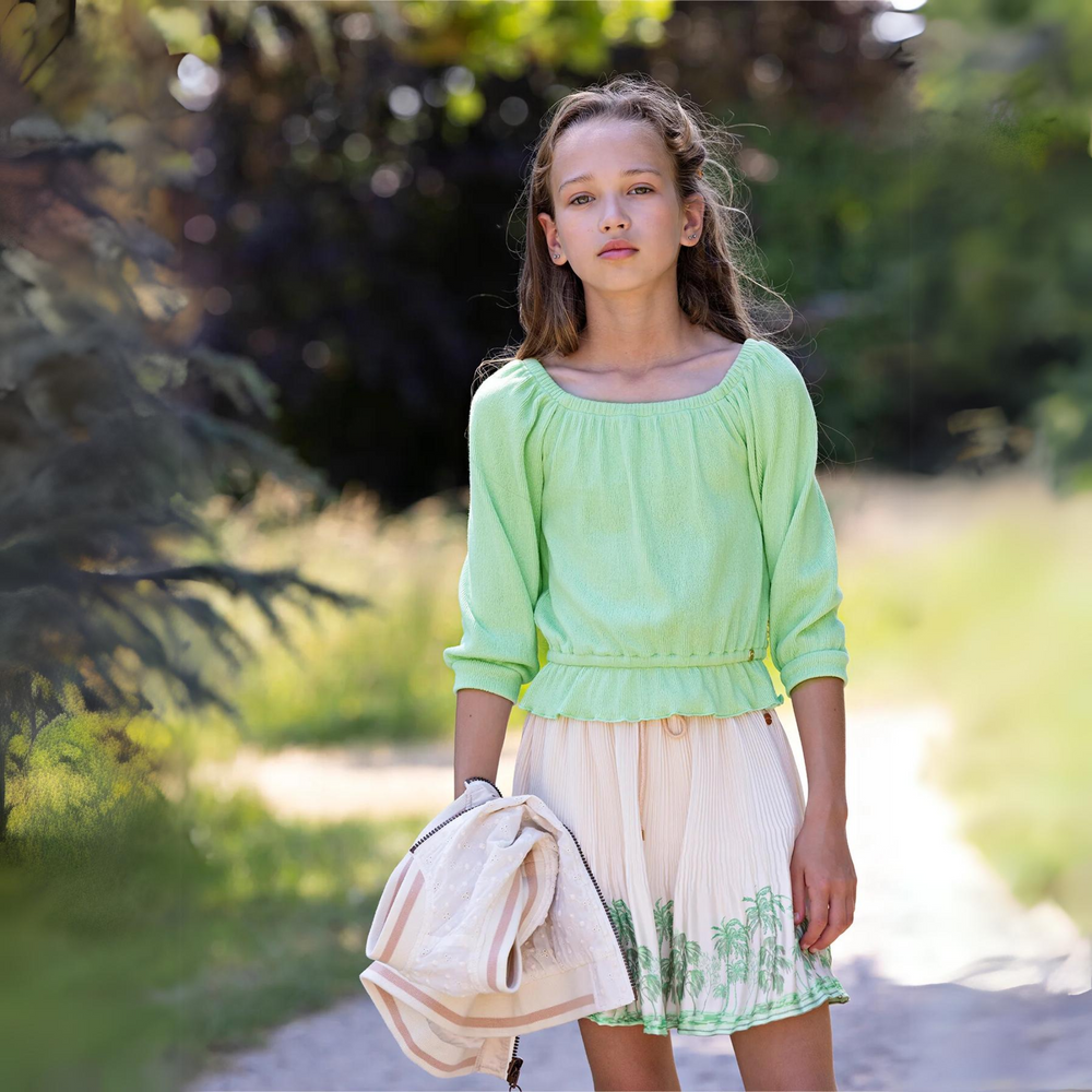 Knew Boat Neck Jersey Top in Spring Meadow Green a girl holding clothes