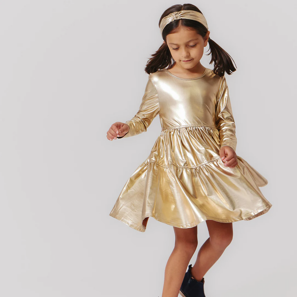 a little girl wearing Lame Polly Dress - Gold