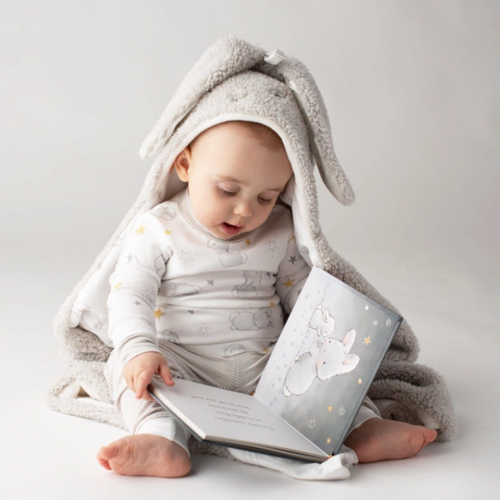 a baby holding the Little Star Board Book