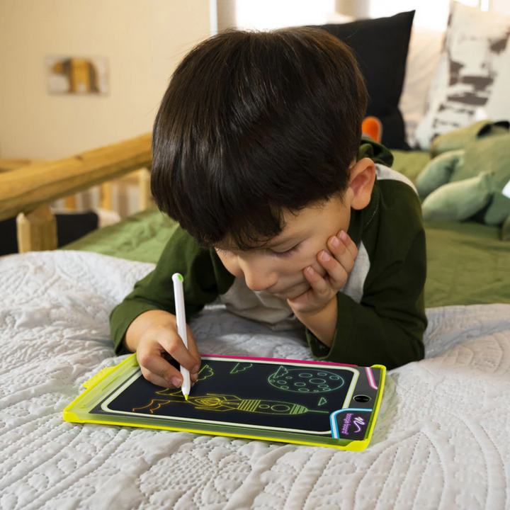 a boy using Magic Sketch Glow Drawing Tablet